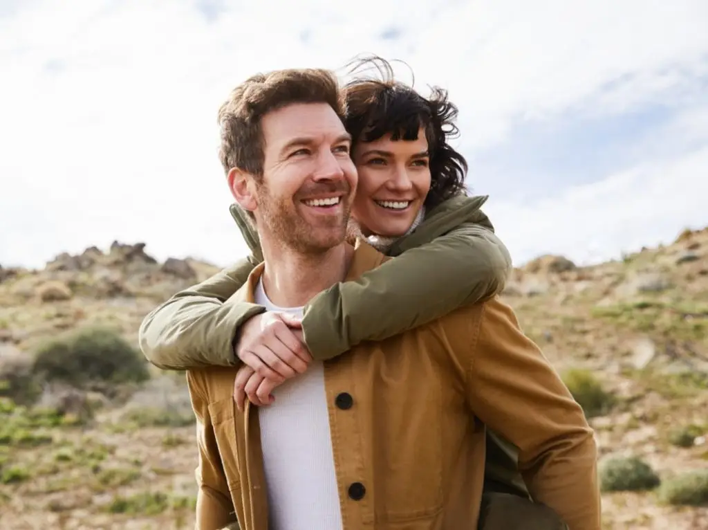 Smiling young couple having fun while out hiking together stock photo